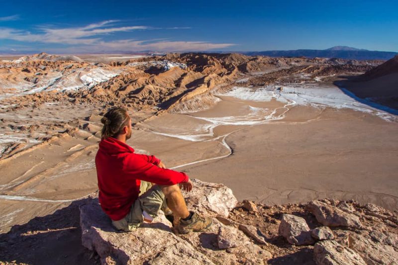 A tourist looks at Moon Valley in the Atacama Desert, Chile._664970416
